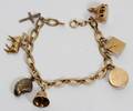 011335 14 KT GOLD CHARMS BRACELET SEVEN CHARMS