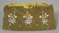 Heavily beaded purse with 3 bouquets of flowers on front with an enamel and beaded clasp