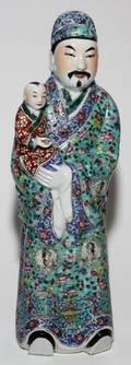 CHINESE PORCELAIN FIGURE OF A DEITY HOLDING A CHILD H