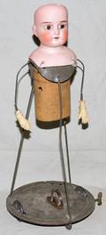 050117 GERMAN BISQUE HEAD AND MECHANICAL DOLL FRAME
