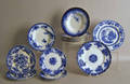 Fourteen flow blue plates and soup bowls