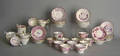 Large group of pink luster cups and saucers