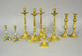 Nine reproduction brass candlesticks