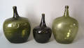 Three large blown green glass bottles