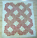 Three red and white pieced quilts