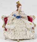 102449 DRESDEN FIGURE IN RED ON SETTEE WFAN H 6