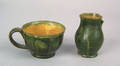 Southeastern Pennsylvania green glazed earthenware cup and small creamer mid 19th c