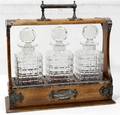 101080 ENGLISH OAK TANTALUS FITTED WTHREE DECANTERS