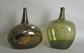 Two green blown glass bottles