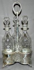 011304 SILVERPLATE TANTALUS FRAME W GLASS DECANTERS