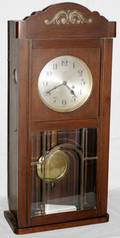 071241 OAK WALL CLOCK WBEVELED GLASSPANELED DOOR