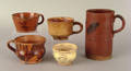 Four American redware mugs early 19th c
