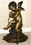 121045 BRONZE SCULPTURE OF A CHERUB H 14 L 20 12