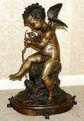 031107 BRONZE SCULPTURE OF CUPID H 14 L 205