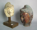 Two carved and painted Buddha heads