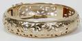 051031 GOLD BANGLE BRACELET W BIRD  FLORAL MOTIFS