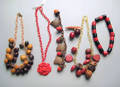 Three celluloidplastic necklaces and a bracelet