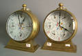 Pair of World Time brass shelf clocks in the form of oversized pocket watches
