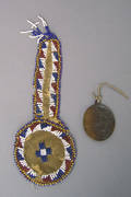 Southern Plains beaded hide pouch and Catholic medal dated 1850