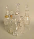Six colorless glass decanters