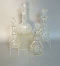 Four colorless glass decanters