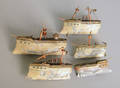 Five painted tin boats