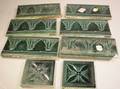 Set of Eight J  JG Low Blue Glazed Molded Pottery Tiles