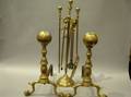 Pair of Brass Belted Balltop Andirons and Set of Three Brass and Iron Tools with a Stand