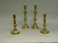 Two Pairs of Brass Candlesticks and a Continental Carved Pine OneDrawer Stand 