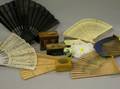 Two Beaded Purses Six Fans Three Marquetry Lithograph and Souvenir Wooden Boxes and a Cloisonne Vase