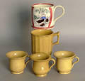 Four yelloware mugs