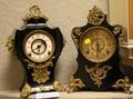 Two Rococostyle Giltmetal Mounted Black Lacquered Iron Mantel Clocks