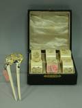Cased Set of Six Carved Ivory Napkin Rings and a Gilt and MotherofPearl Decorated Ivory Hair Comb