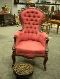 Victorian Carved Walnut and Upholstered Parlor Armchair and a Round Needlepoint Upholstered Footstool