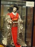 Asian Carved Giltwood Panel and a Japanese Traditional Dressed Doll