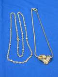 Gold Chain Suspending a Gold and Diamond Heart and a Gold and Diamond Necklace