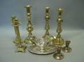 Two Pairs of Brass Candlesticks a Silver Plated Gravy Boat a Pair of Sterling Candleholders and a Brass Candlestick