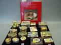 Eighteen Small Contemporary Enamel Decorated Lidded Boxes and a Book