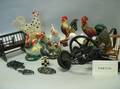 Group of Cast Iron Trivets Irons Ceramic and Decorated Rooster Figures a Pair of Andirons Kitchen Items and Miniature Furniture