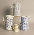 Four blue and white spongeware pitchers
