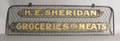 Sheet metal trade sign for  E Sheridan Groceries and Meats