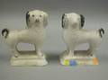 Pair of Chalkware Spaniels the spaniels with black painted ears tail facial features and paws on a white ground minor base chips