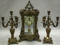 Ansonia Rococostyle Gilt Bronze and Glass Mantel Clock and a Pair of Gilt Metal Thr ThreeArm Candelabra