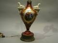 Egyptian Revival Porcelain Lamp Base c 1900 urnform with two bisque sphinxform handles with a reserve of a biblical couple at a