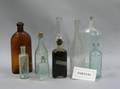 Group of Fifteen Colored and Colorless Molded Glass Bottles