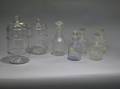 Seven Assorted Colorless Glass Canisters Decanters and Bottles