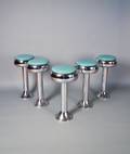 Five chrome revolving counter stools