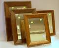 Four Mahogany Veneer Framed Mirrors