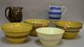 Three Yellowware Bowls a Pitcher and a Glazed Stoneware Pitcher and Mixing Bowl