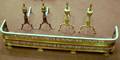 Two Pairs of Brass Andirons and a Pierced Brass Fireplace Fender